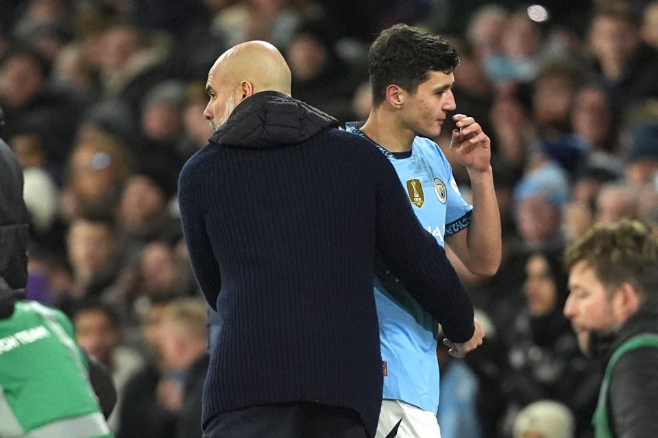 Manchester City manager Pep Guardiola congratulates Abduqodir Khusanov after substituting him.