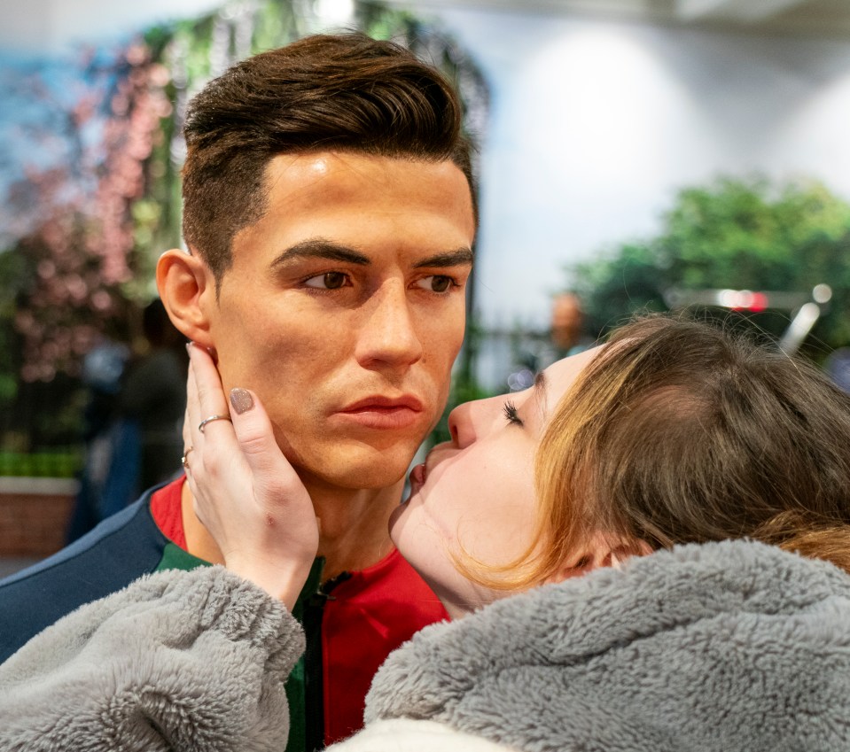 A woman kissing a Cristiano Ronaldo wax figure at Madame Tussauds.