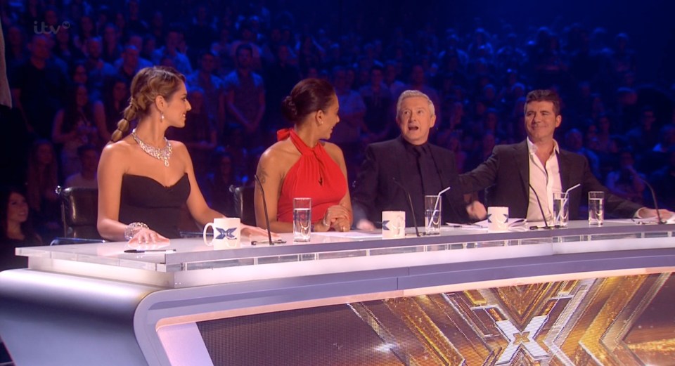 The X Factor judges at the judging table.