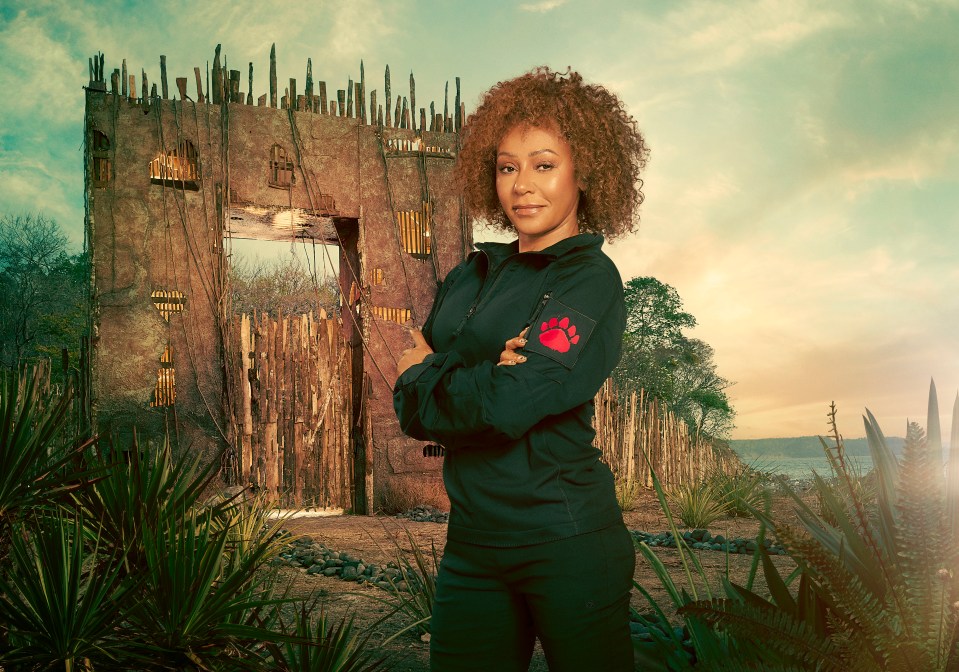 Mel B standing in front of a dilapidated structure, arms crossed.