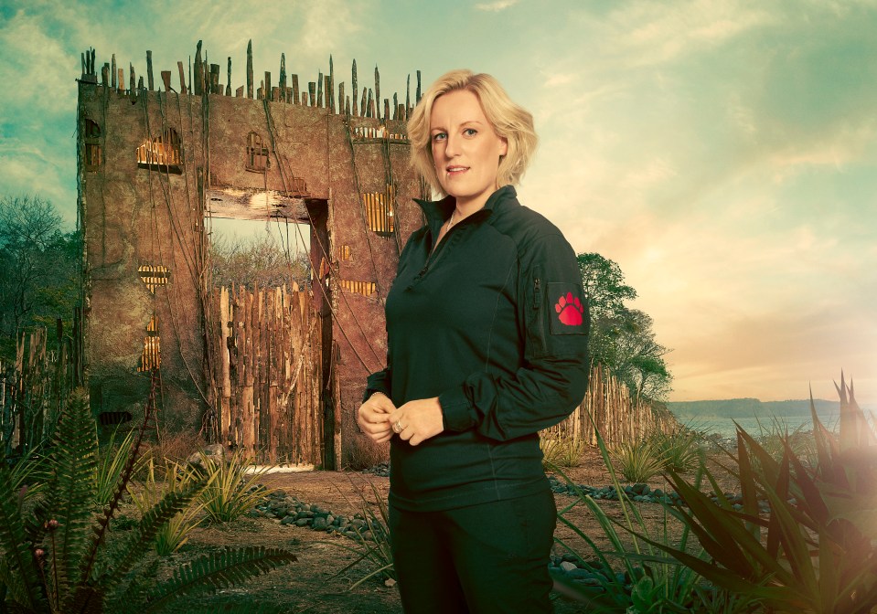 Woman standing in front of a dilapidated structure.