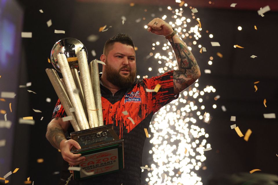 Michael Smith holding the Sid Waddell trophy after winning the PDC World Darts Championship.