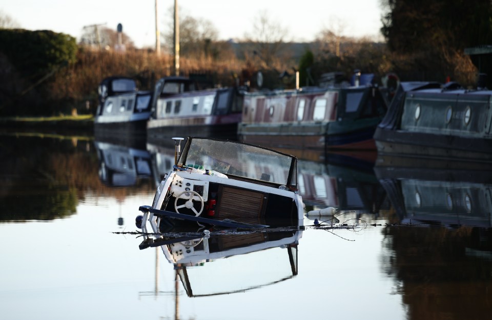 Sunken boat in Bridgewater Canal after embankment collapse.