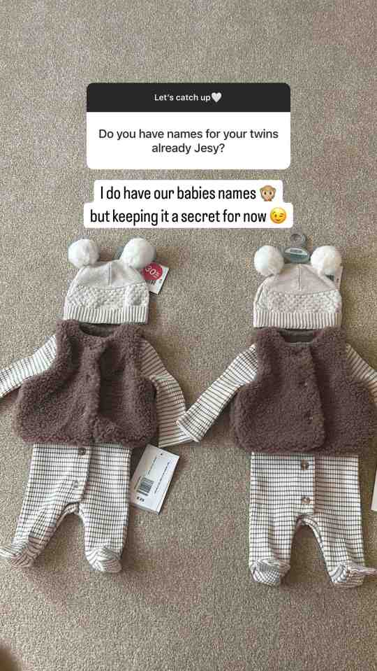 Two identical baby outfits with hats, and a text exchange revealing the names of twins are being kept secret.