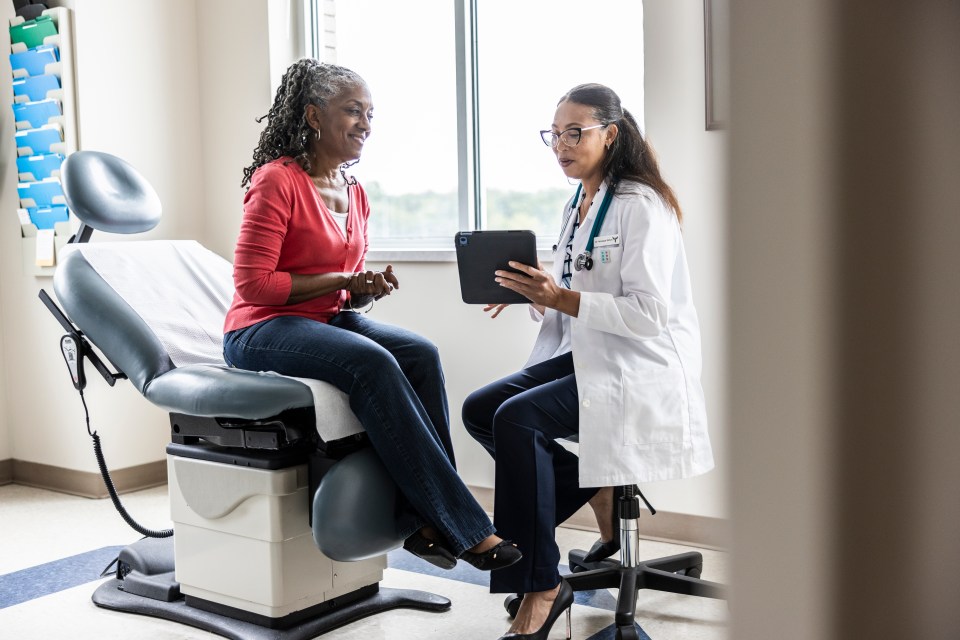 Doctor and patient reviewing information on a tablet.