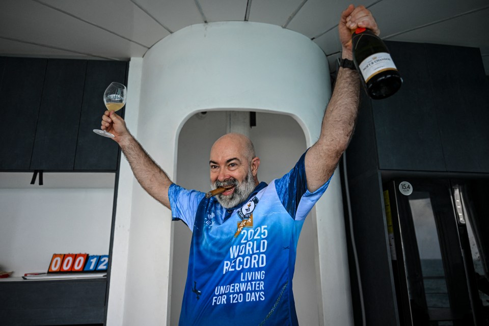 Man celebrating a world record for living underwater.