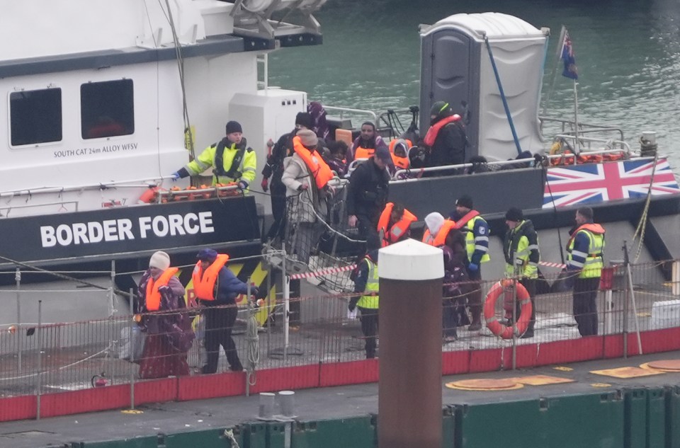 Migrants disembarking a Border Force vessel in Dover.