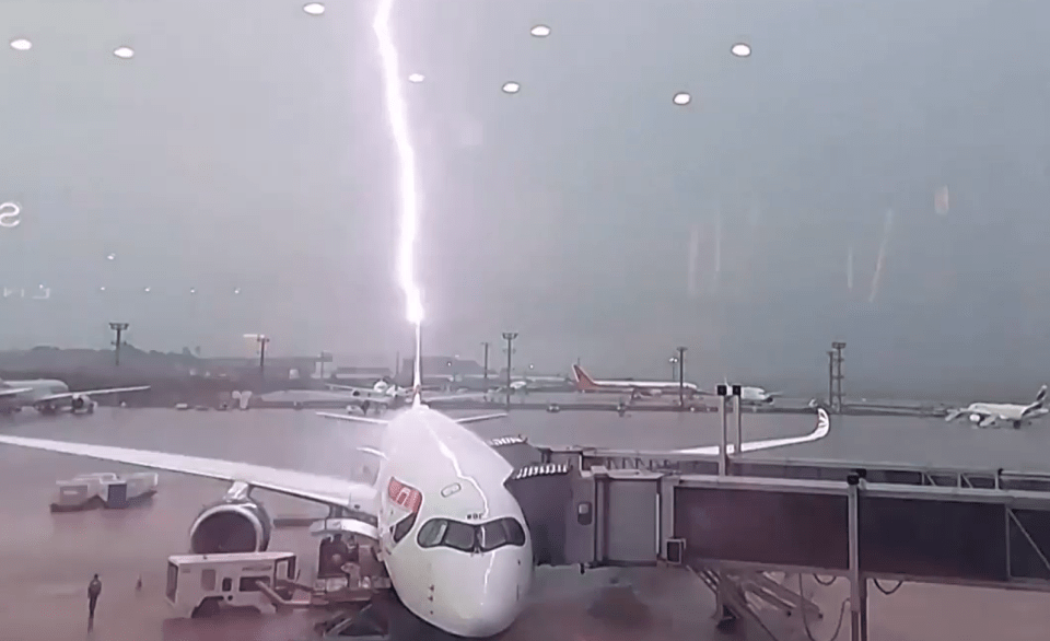 Lightning striking an airplane at an airport.