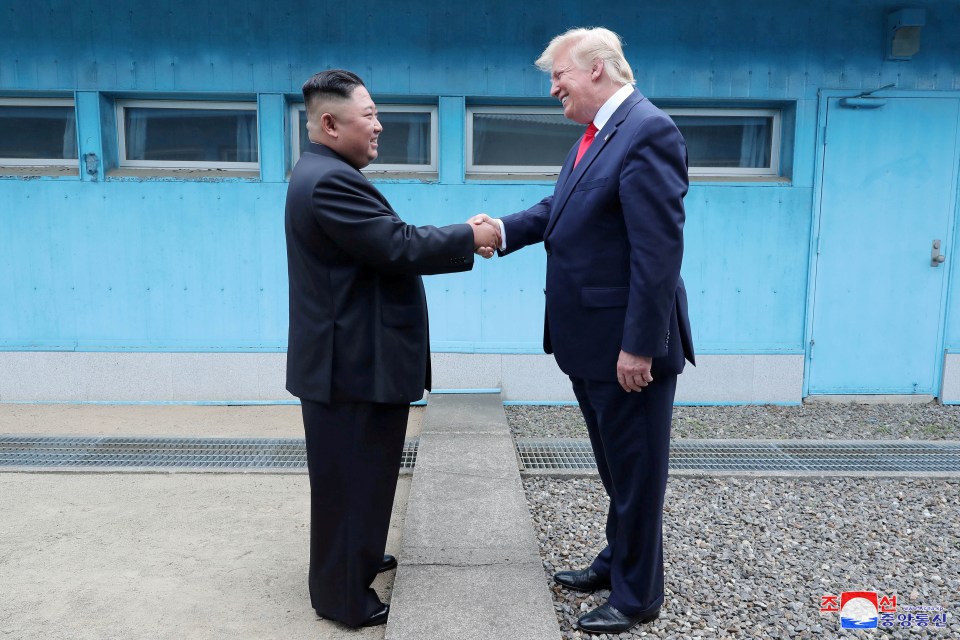 Donald Trump and Kim Jong Un shaking hands at the DMZ.