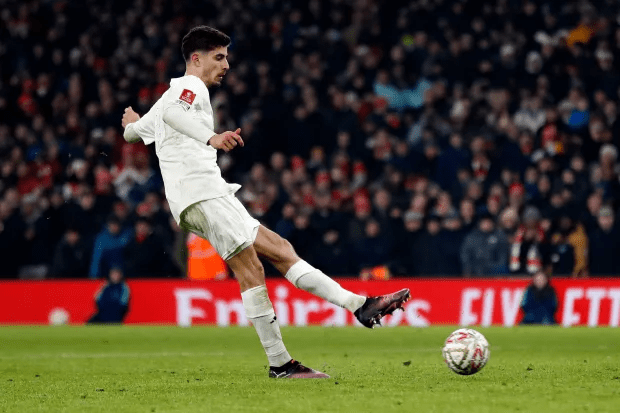Soccer player kicking a ball.