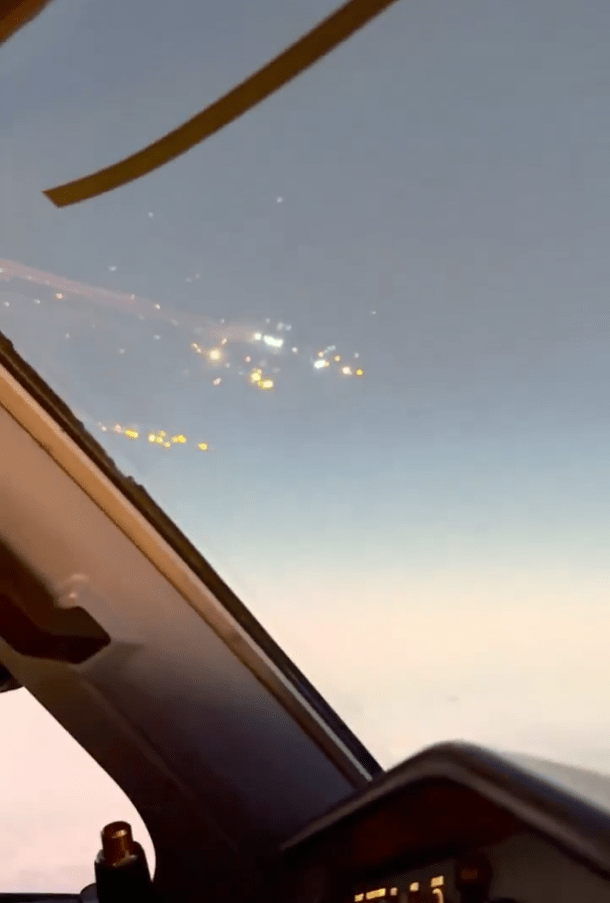 Airplane view of city lights at night.