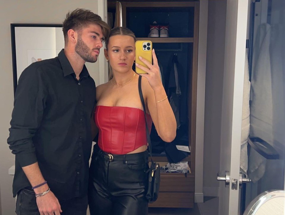 Couple taking a selfie in a hotel room.