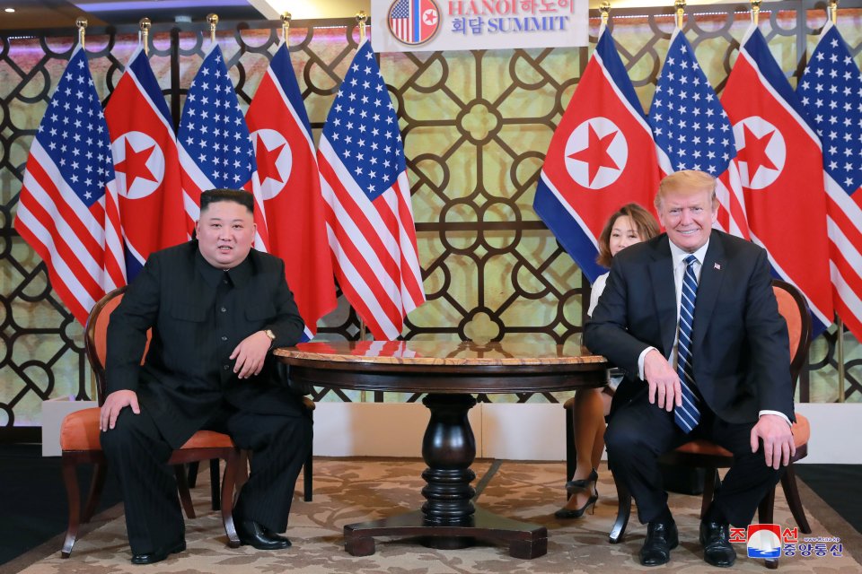 Kim Jong Un and Donald Trump seated at a table during the Hanoi Summit.