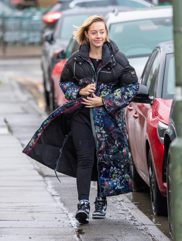 Kelsey Parker walking down a sidewalk.