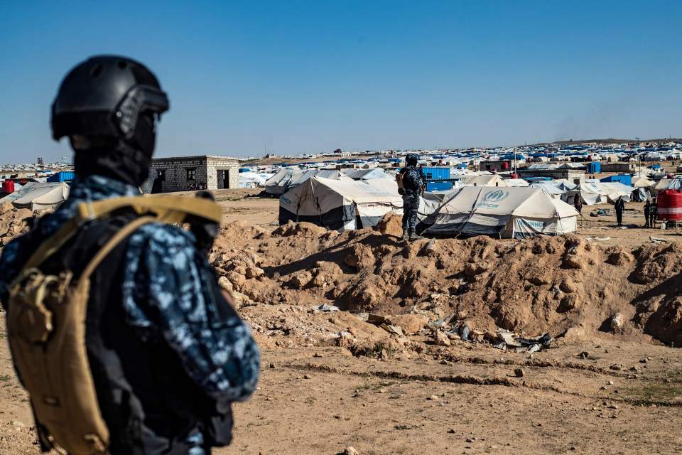 Syrian Democratic Forces soldier overlooking a displacement camp.