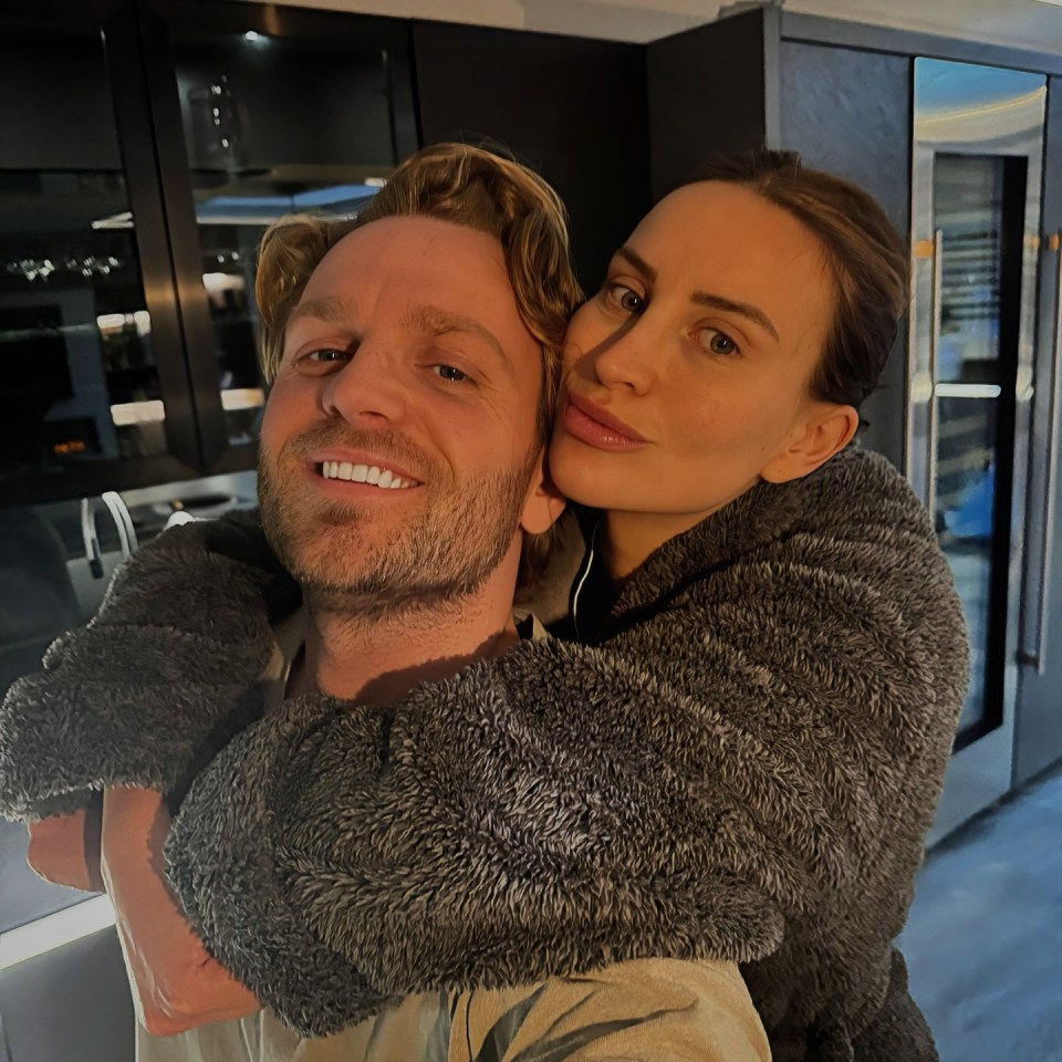 Couple embracing in a kitchen.