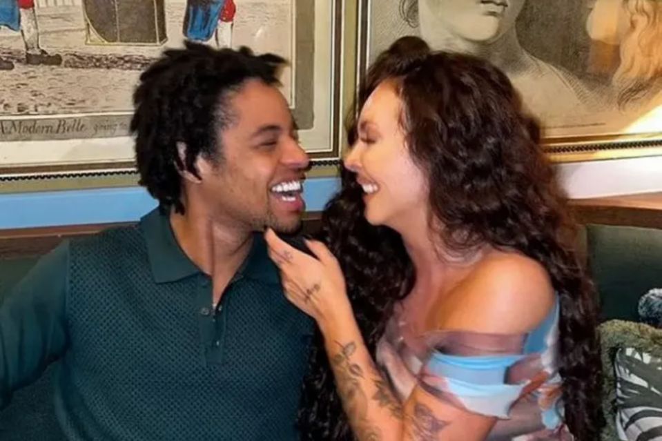 Jesy Nelson and her rap singer partner Zion smiling at each other.