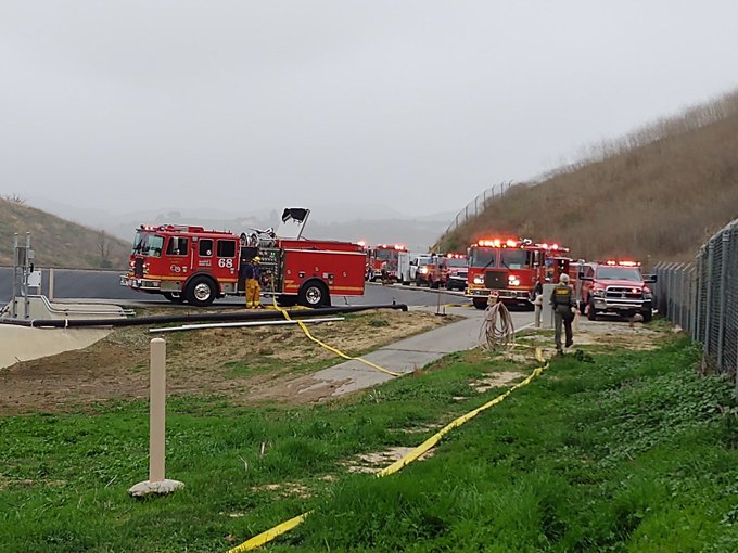 Fire trucks at the scene of a helicopter crash.