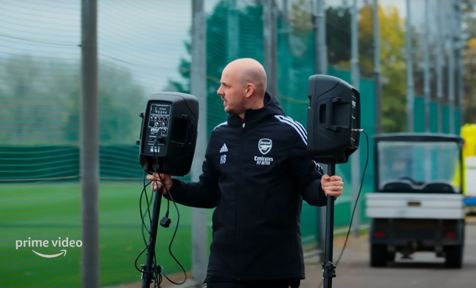Mikel Arteta carrying speakers at Arsenal training.