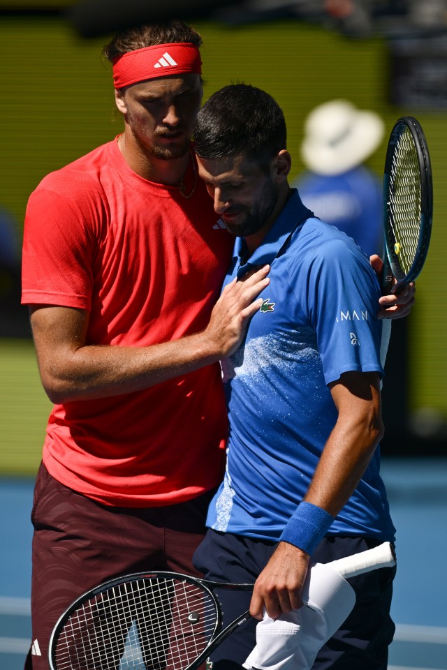 Novak Djokovic of Serbia embraced by Alexander Zverev of Germany after retiring from a tennis match.