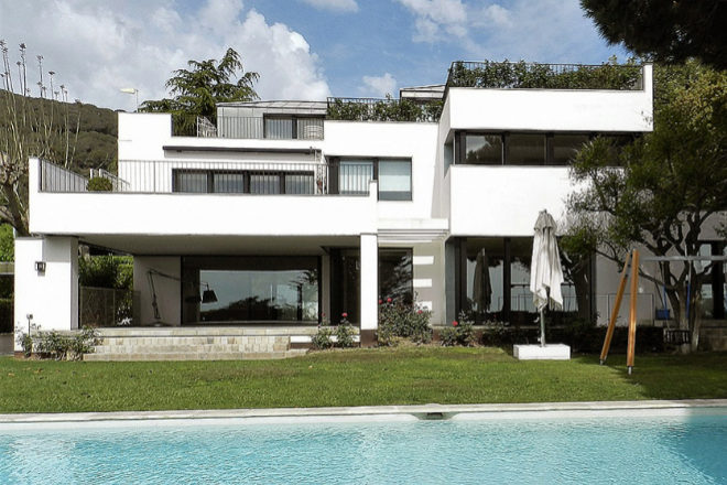 Large white house with a swimming pool.