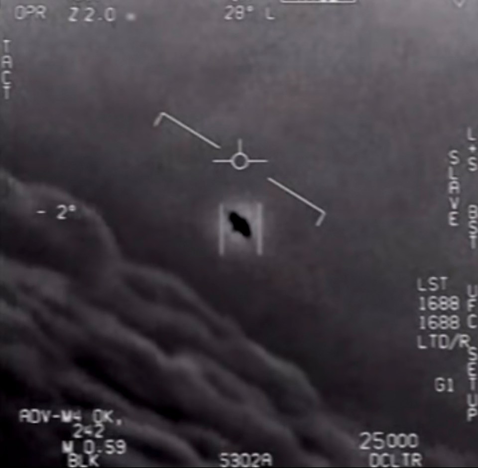 Grainy black and white video still of unidentified aerial phenomena.