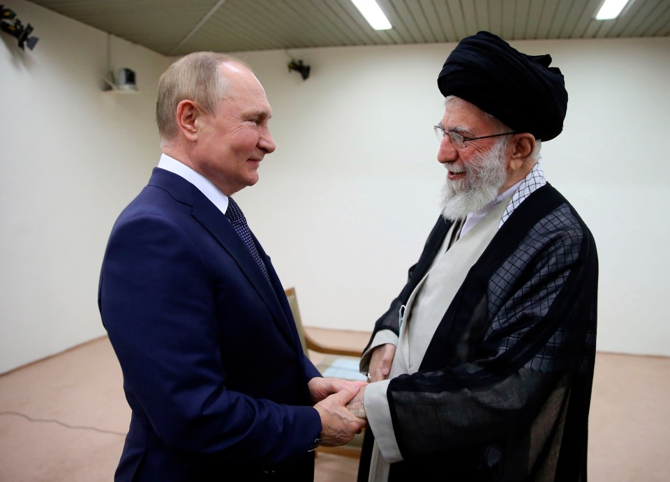 Vladimir Putin and Ayatollah Ali Khamenei shaking hands.