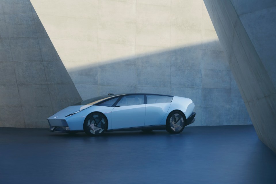 Light blue Honda 0 Saloon in modern setting.