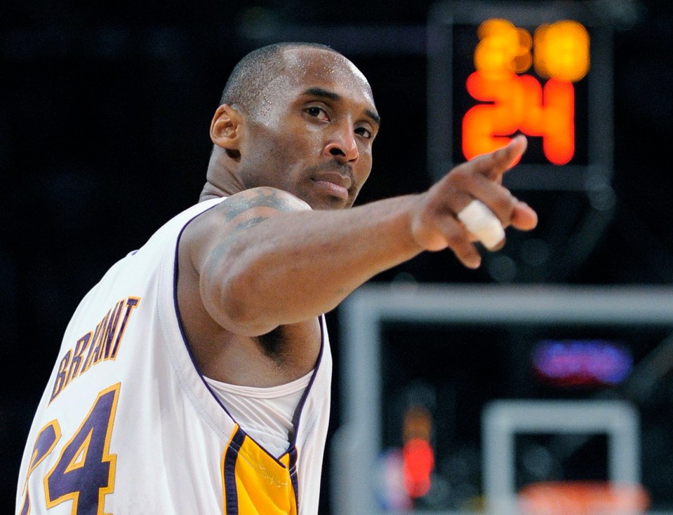 Kobe Bryant pointing to a player after making a basket.