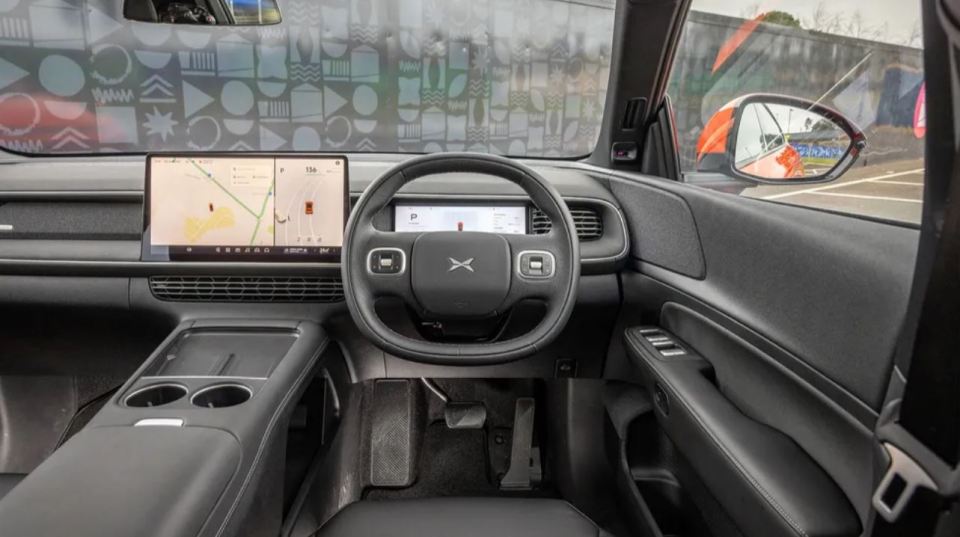 Interior view of a car's dashboard and steering wheel.