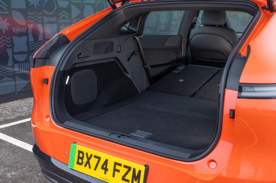 Open trunk of an orange electric car.