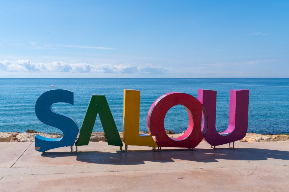 Colourful sign giving the name of the popular tourist destination Salou Costa Dorada Catalonia Spain<br />
on Tuesday 4th October 2022