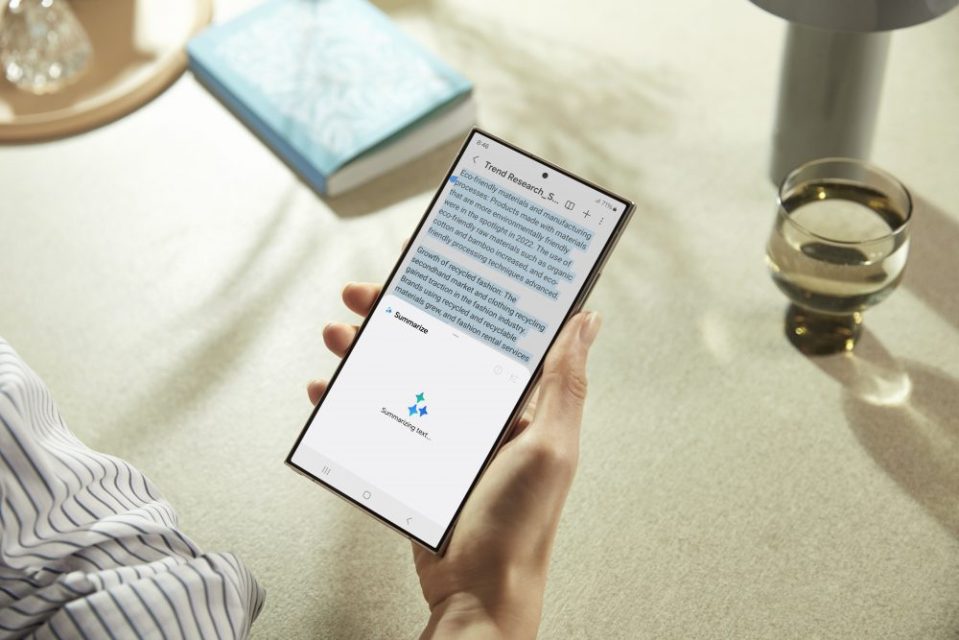 Person holding phone displaying text about eco-friendly materials and recycled fashion.