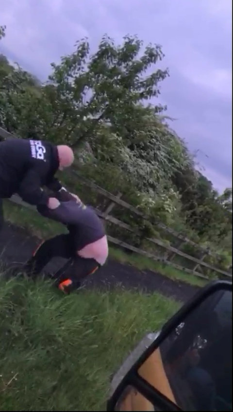 Police officer grabbing a man by the throat.