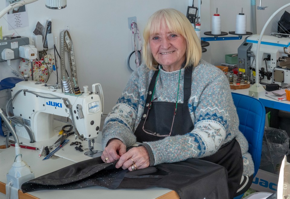 A woman sewing at a sewing machine.