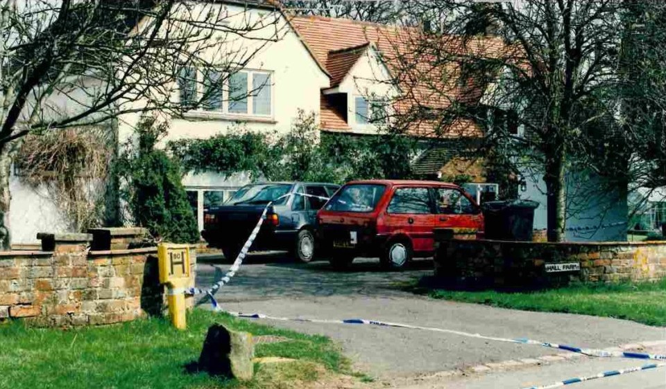 Crime scene outside a house with police tape.