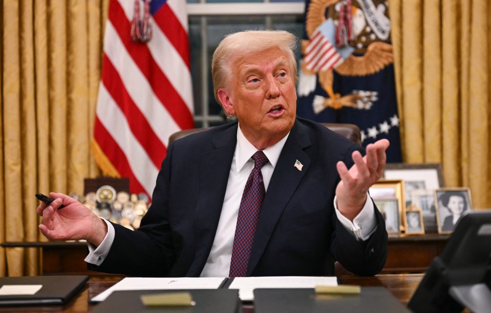 President Trump signing pardons in the Oval Office.