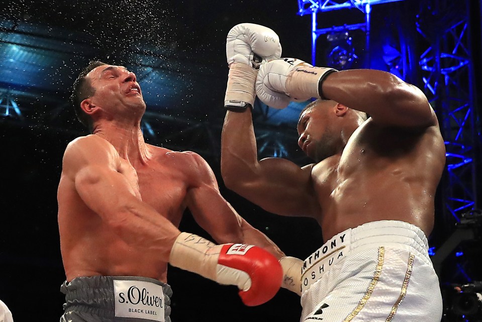 Anthony Joshua landing a punch on Wladimir Klitschko during a boxing match.