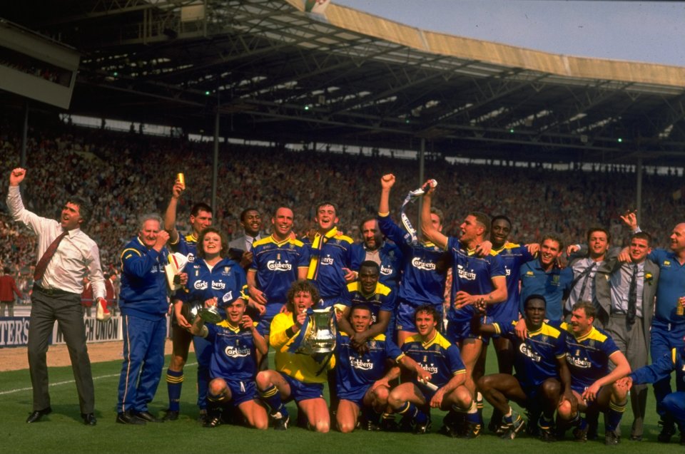 Wimbledon team celebrates FA Cup victory at Wembley Stadium.
