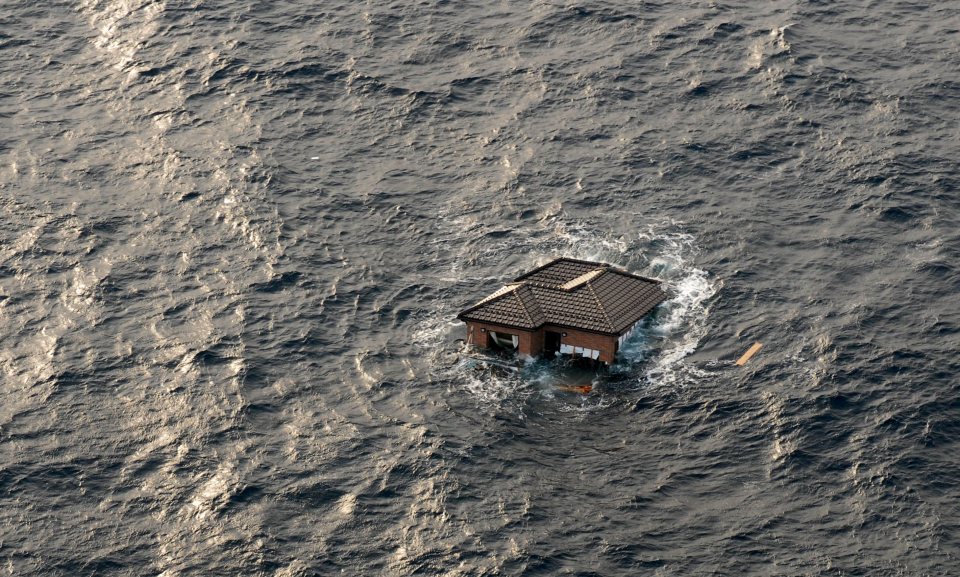 House adrift in ocean after tsunami.