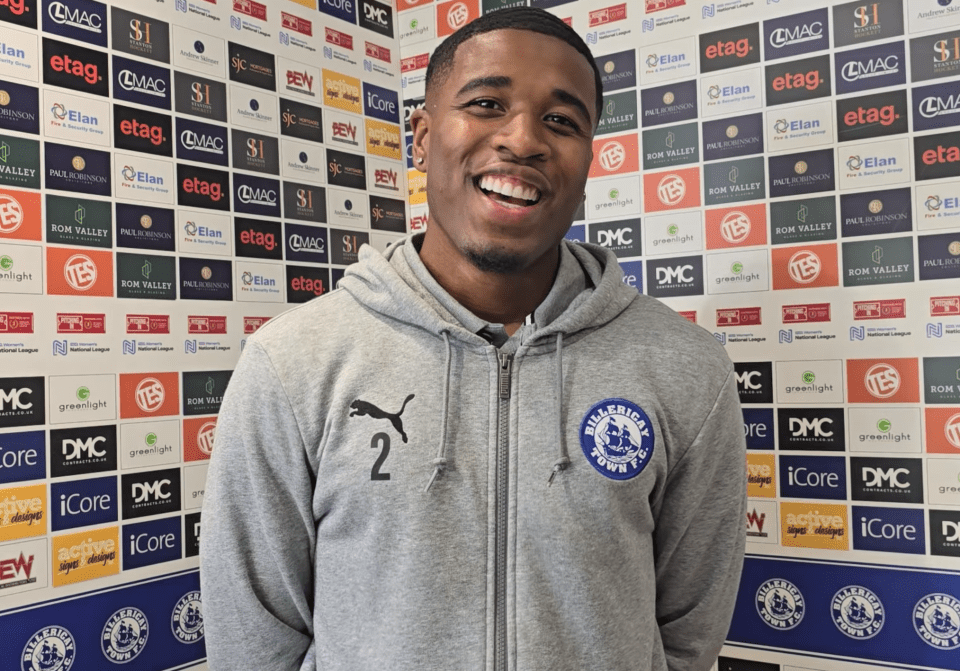Montel McKenzie smiling, wearing a gray Billiercay Town F.C. hoodie.