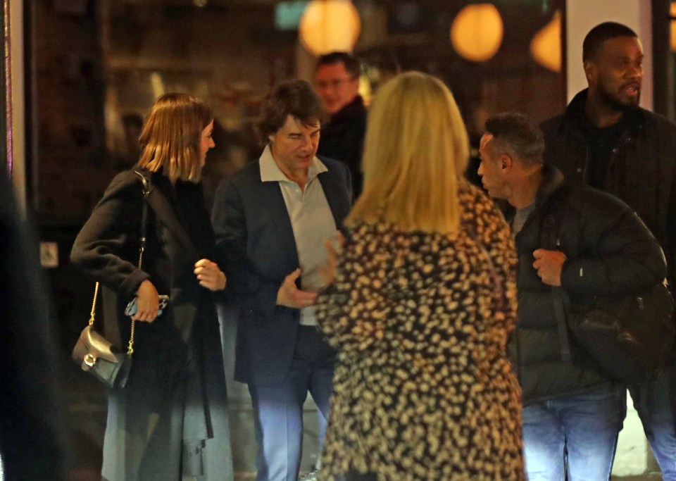 Tom Cruise and Ana de Armas leaving a restaurant.