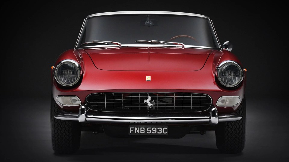 Front view of a red 1965 Ferrari 275 GTS.