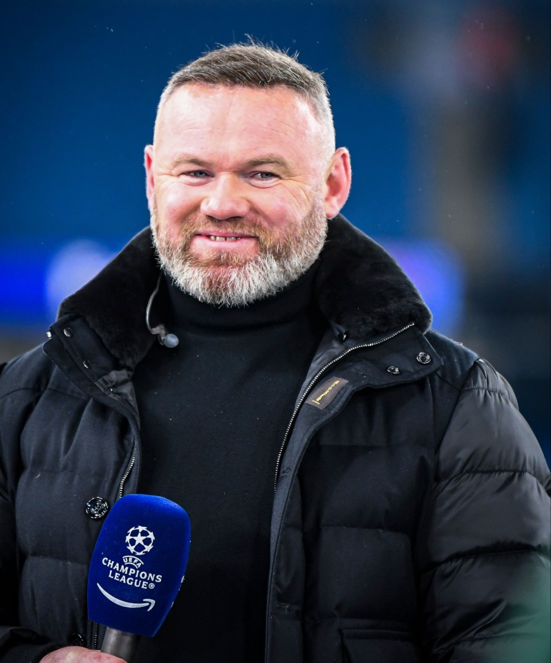 Wayne Rooney holding a UEFA Champions League microphone.