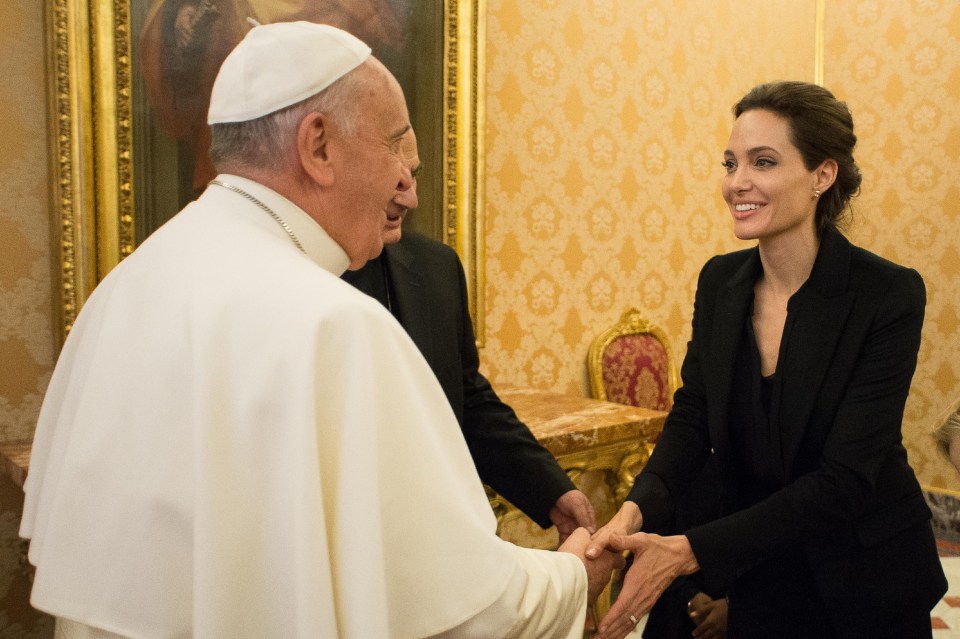 Pope Francis shaking hands with Angelina Jolie at the Vatican.