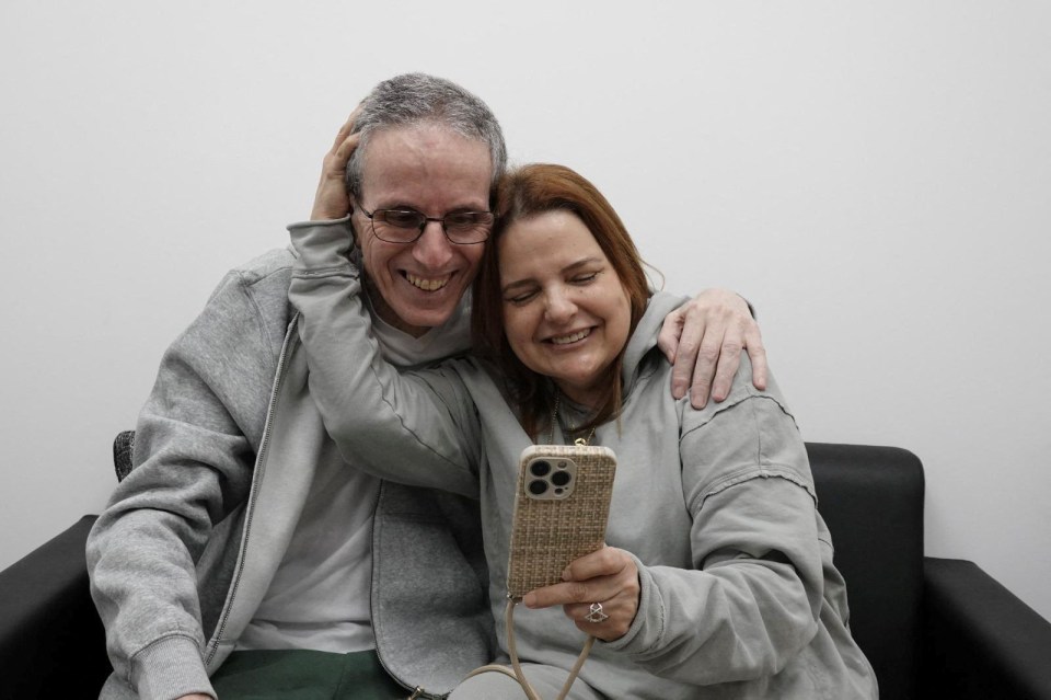 Released hostage embracing a loved one.