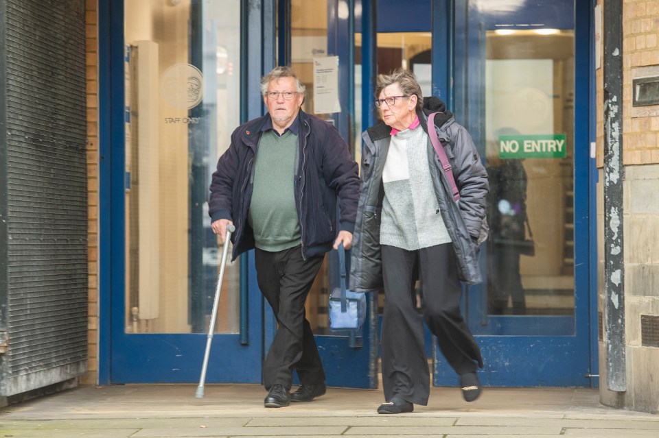 Elderly couple leaving a courthouse.