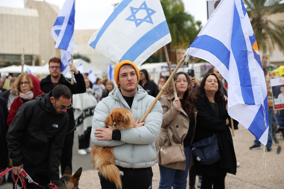Protestors in Tel Aviv hold Israeli flags and wait for the release of hostages.
