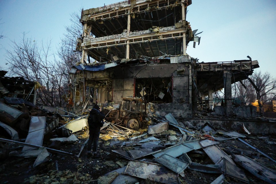 A person stands amidst the rubble of a bombed-out building in Kyiv, Ukraine.