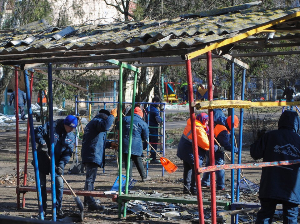 Cleanup crew removing debris from a damaged kindergarten playground in Odesa, Ukraine.
